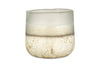 A translucent, frosted glass cup with a rounded shape and a gradient from clear to white with gold-speckled accents holds the nkuku Cardamom & Amber 3 Wick Scented Candle.