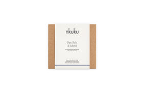 A nkuku Sea Salt & Moss 3 Wick Scented Candle in eco-friendly brown and white packaging features a bespoke, soothing fragrance and a recyclable clear holder. Expertly crafted in the UK.