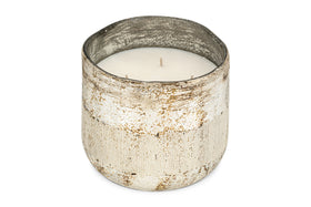 The nkuku Juniper & Fir 3 Wick Scented Candle features a rustic, weathered silver container with a textured finish and uneven rim, creating an inviting atmosphere with its bespoke fragrance.