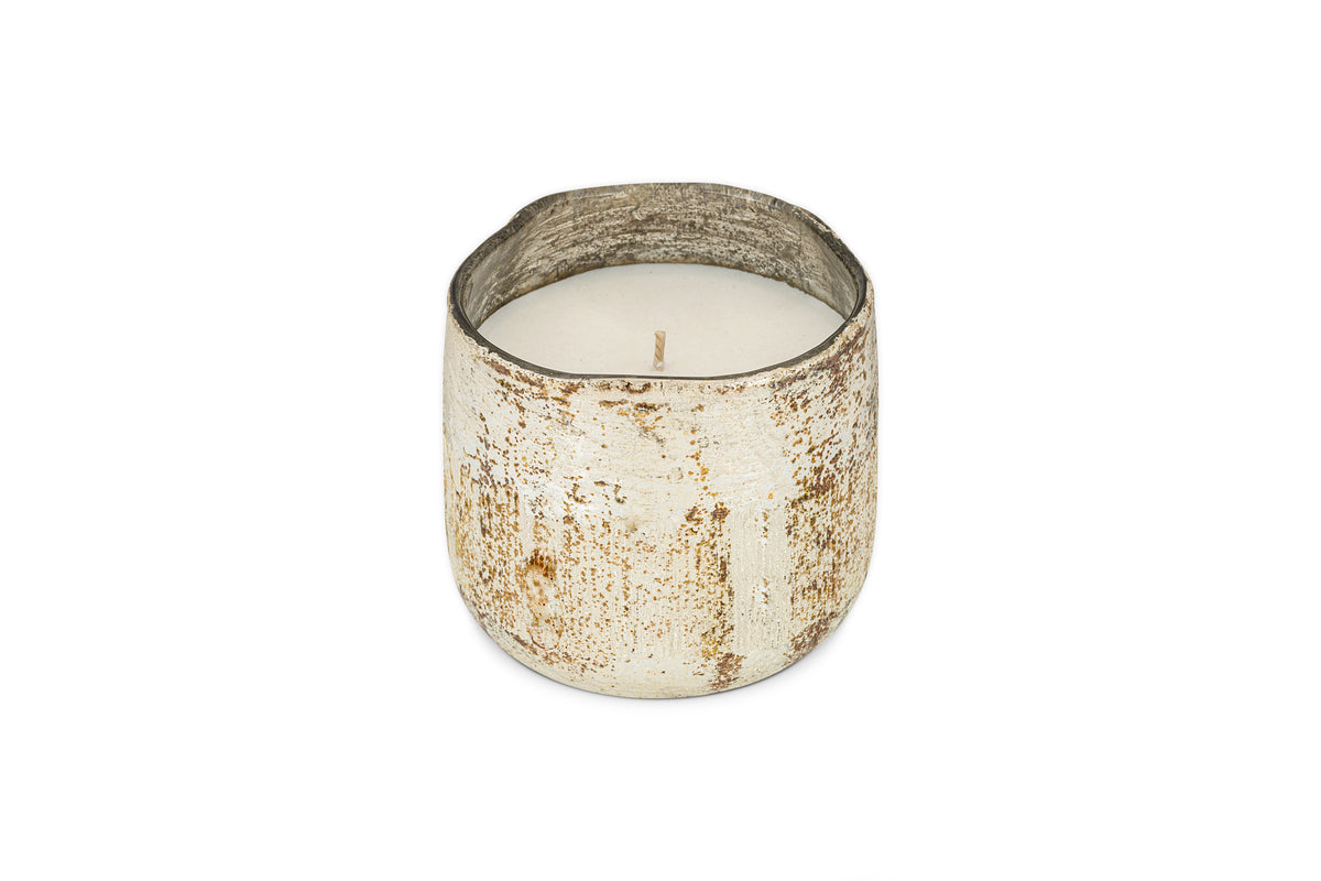 The nkuku Mandarin & Clove 1 Wick Scented Candle, presented in a distressed white metal container, releases a festive spiced mandarin aroma and is shown on a plain white background.