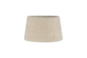 The Sakiti Bouclé Lampshade by nkuku features an off-white, cone-shaped woven fabric design with a classic tapered silhouette, ideal for ambient lighting. Displayed against a plain white background.