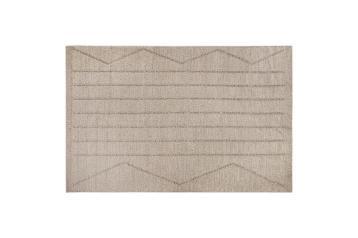 The nkuku Shanti Wool & Cotton Rug - Natural is a beige rectangular area rug with a textured surface and horizontal and zigzag line patterns, shown on a white background.
