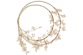 The nkuku Tanu Layered Mango Wood Beaded Wreath features natural wood and brass beads in a layered design, creating an elegant, minimalist look—ideal for festive decorating against a crisp white background.