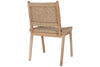 The Vinay Woven Armless Dining Chair by nkuku features a woven jute seat and backrest, acacia wood frame with a natural rustic finish, and simple straight legs, shown from behind at an angle.