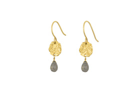 The Veera Labradorite Earrings - Gold by nkuku feature textured gold-toned discs with teardrop-shaped gray labradorite gemstones hanging below, set against a white background.