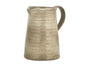 The Valinha Earthenware Jug - Grey - Small by nkuku features a textured finish, curved handle, and small spout—unique tableware to elevate your dining. Displayed against a plain white background.