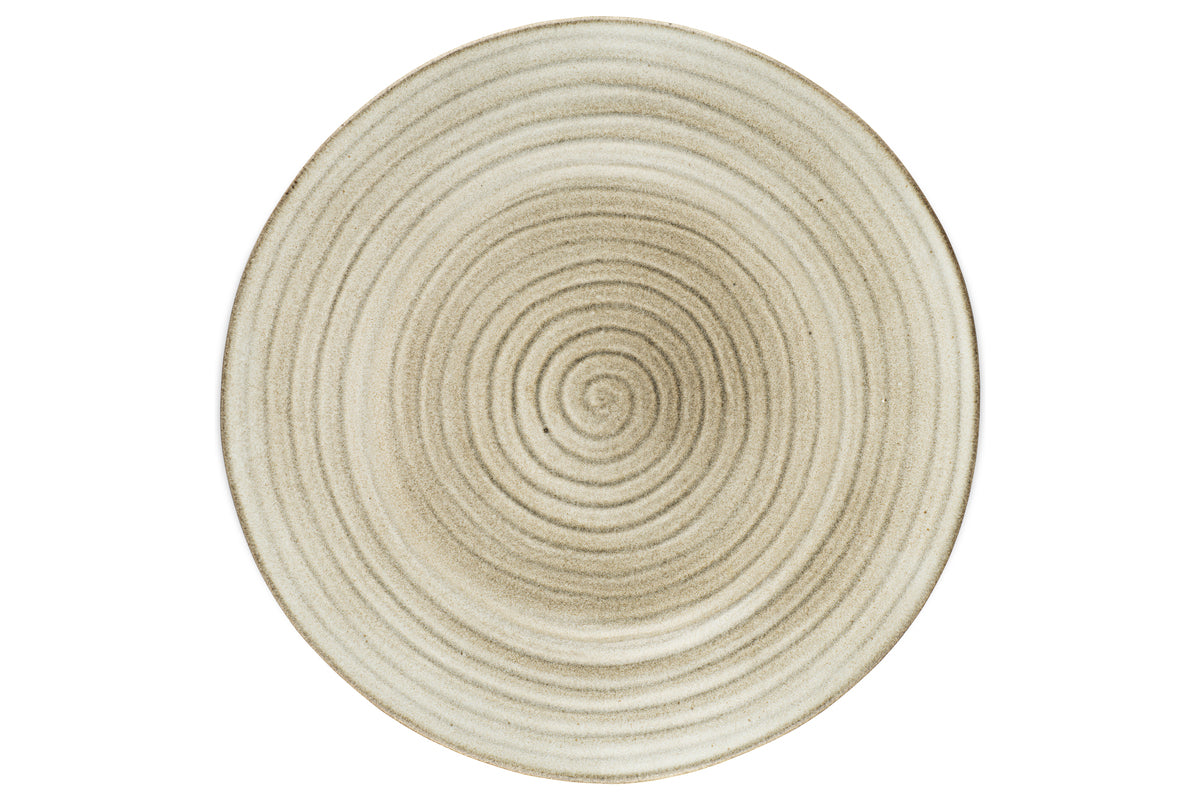 The nkuku Valinha Earthenware Round Platter in grey is an oversized ceramic platter featuring a textured concentric circle pattern and a reactive glaze.