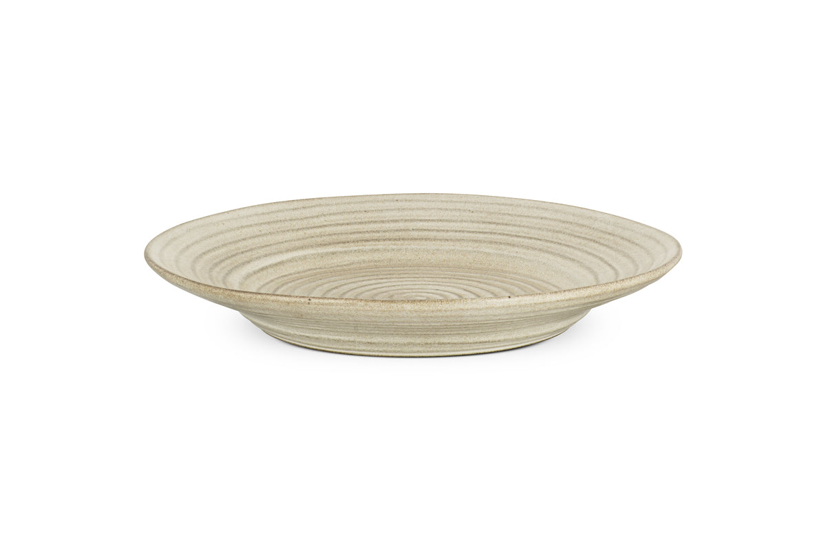 The nkuku Valinha Earthenware Round Platter in grey features a reactive glaze, shallow depth, and concentric ridges, adding stylish charm to your serveware collection. Set against a white background.