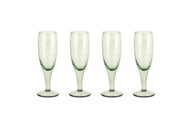 The nkuku Yala Hammered Champagne Glasses (Set of 4) in sage green feature textured, hammered glass and are shown side by side on a white background.