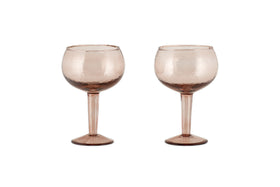 Two Yala Hammered Gin Glasses in Dusty Terracotta by nkuku, featuring textured, round bowls and elegant hammered detailing, are displayed side by side on a white background. Set includes 2 glasses.