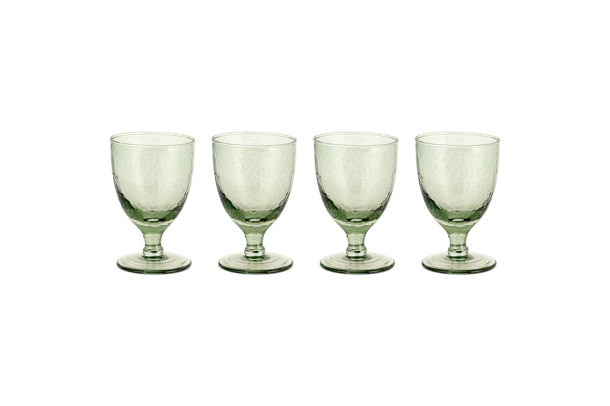 Four sage green Yala Hammered Wine Glasses by nkuku are arranged in a row on a white background. Set of 4.