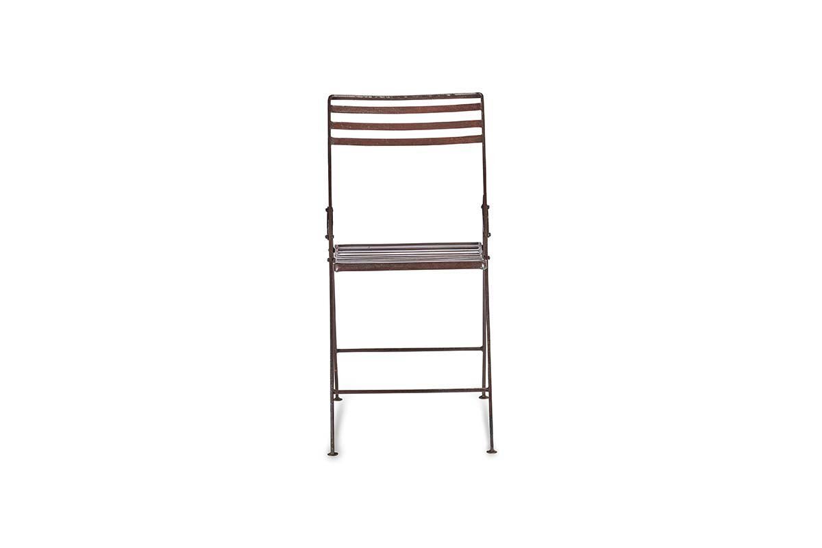 A front-facing nkuku Yealme Iron Bistro Chair with a dark brown finish features horizontal slats on the seat and backrest, slim sturdy legs with hinges and support bars, evoking classic industrial outdoor style. The background is plain white.