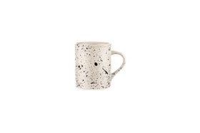 The nkuku Ama Mug - Tall features a white ceramic base with unique black speckles and splatter, highlighting the distinctive artistry of the Ama collection.