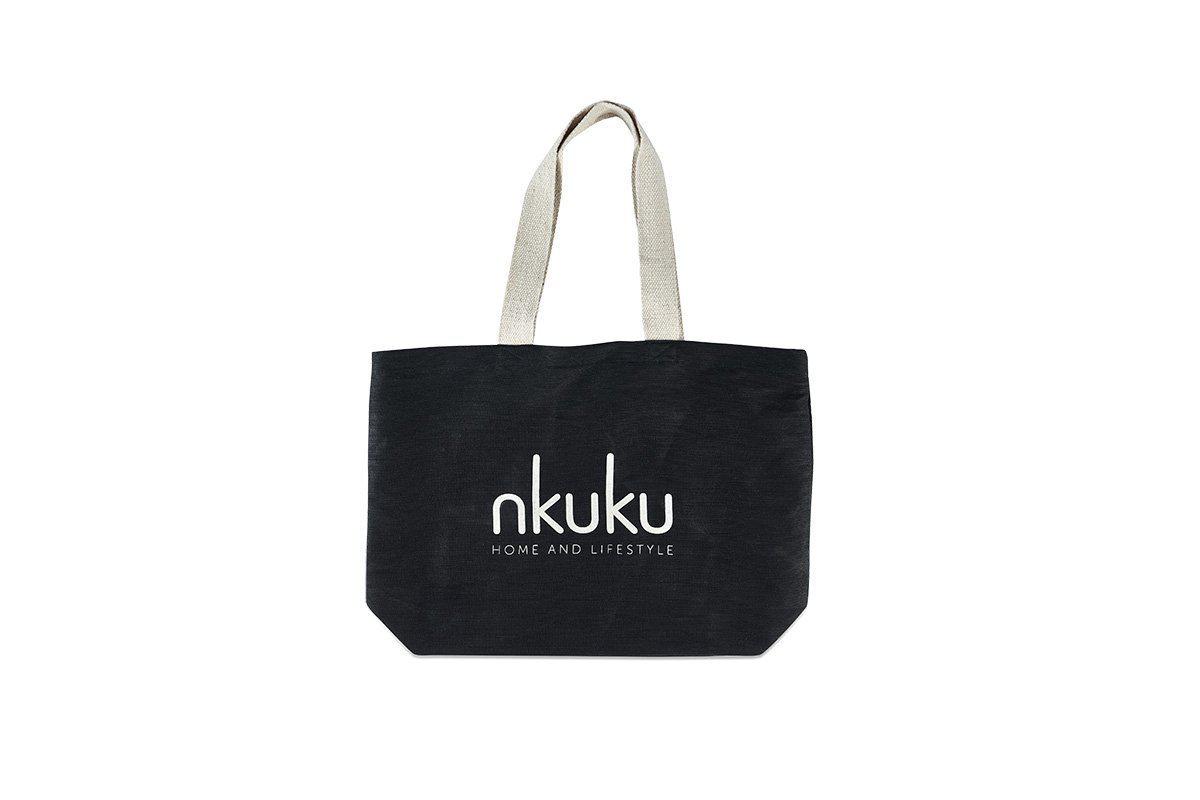 A black Jute & Cotton Tote Bag by nkuku with beige handles is centered on a white background. Large white "nkuku" text and smaller "HOME AND LIFESTYLE" appear on the bag.